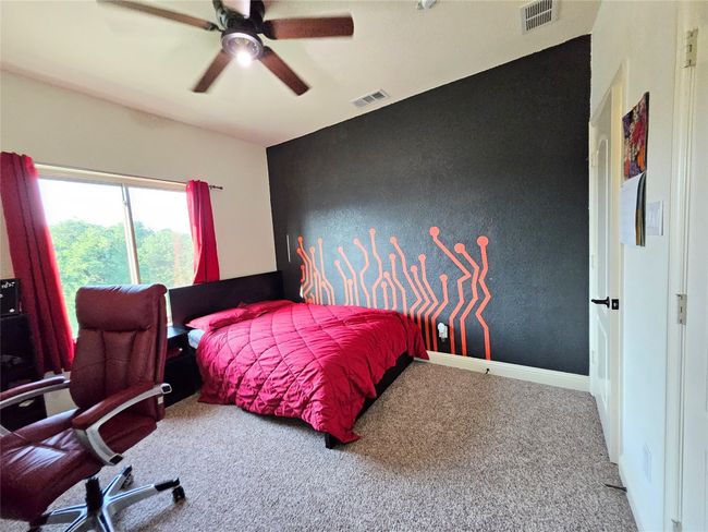 Carpeted bedroom with ceiling fan and baseboards | Image 32