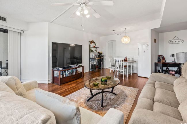 Super Bright Living Room with Floor to Ceiling Glass; Ceiling Fan; and LVP wood-look flooring. | Image 8
