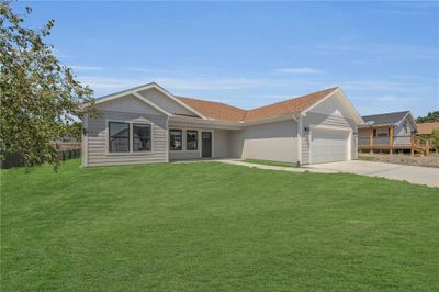 Ranch-style home with a front lawn and a garage | Image 3