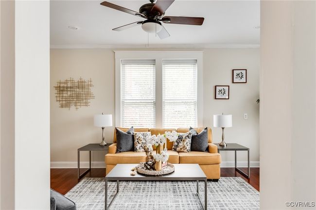 Living room featuring baseboards, crown molding, wood finished floors, and a ceiling fan | Image 21