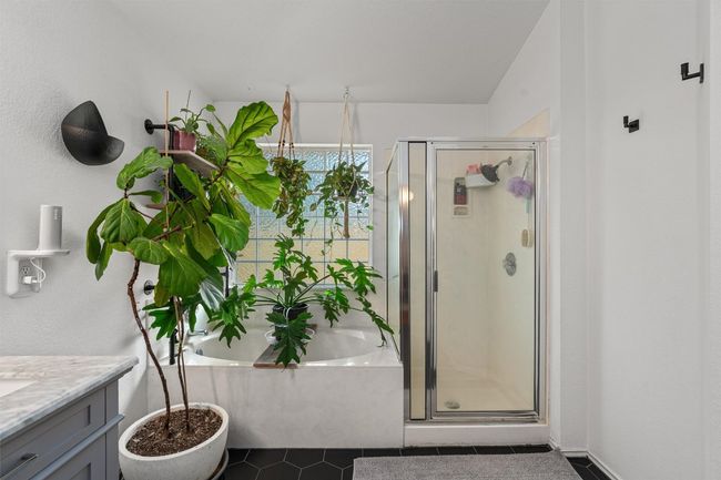 Full bathroom with vanity, a shower stall, a garden tub, and tile patterned flooring | Image 21