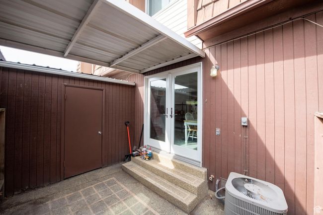 View of exterior entry featuring central AC and french doors | Image 19