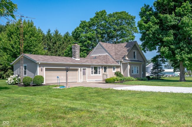 Side view with picture of large 2 car garage with workbench area and storage. | Image 10