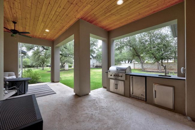 View of patio featuring area for grilling and a ceiling fan | Image 5