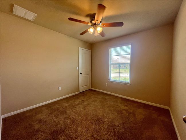 Carpeted bed room with baseboards and ceiling fan | Image 4