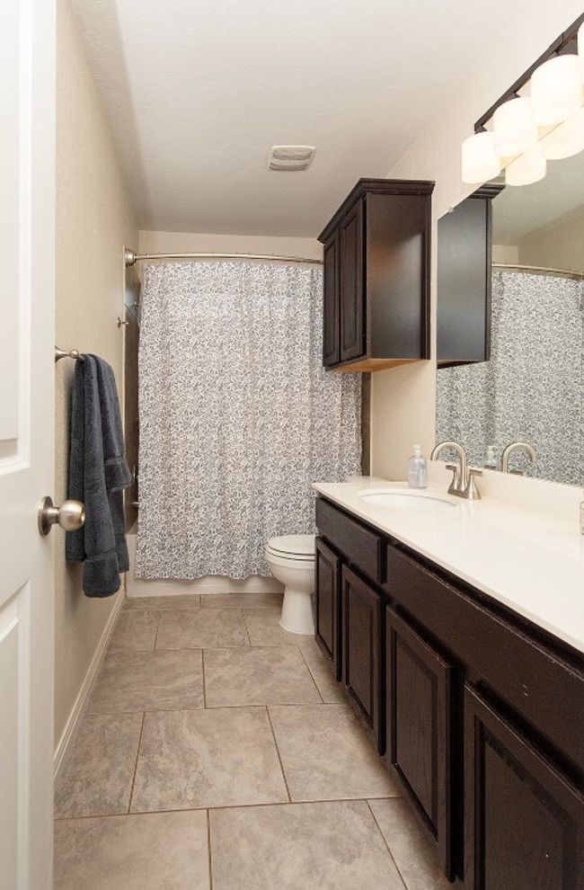 Bathroom with toilet, vanity, and tile patterned flooring | Image 20