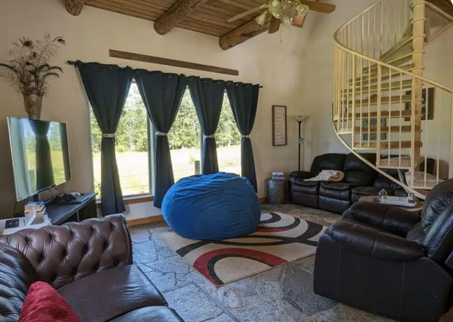 Living room with circular stairway | Image 17