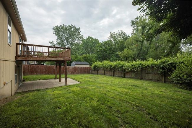 View of yard featuring a patio area and a wooden deck | Image 34