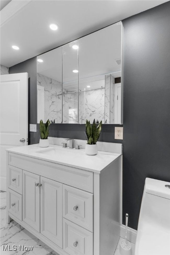 Full bath with marble finish floors, vanity, and recessed lighting | Image 24