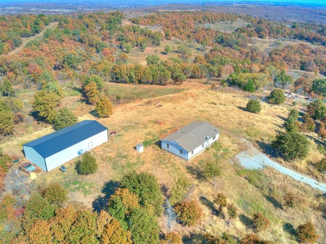 Looking form the SW to the NE. Property line begins ~20' from garage on each side allowing for a drive on the N side to 10' door designed to be the Shop entrance. | Image 10