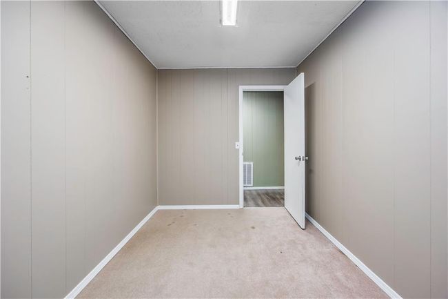 Carpeted spare room featuring visible vents and baseboards | Image 11
