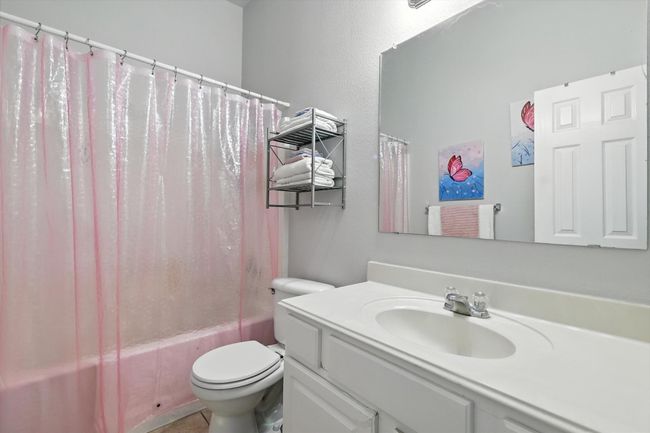 Full bath featuring vanity and shower / bath combo with shower curtain | Image 15