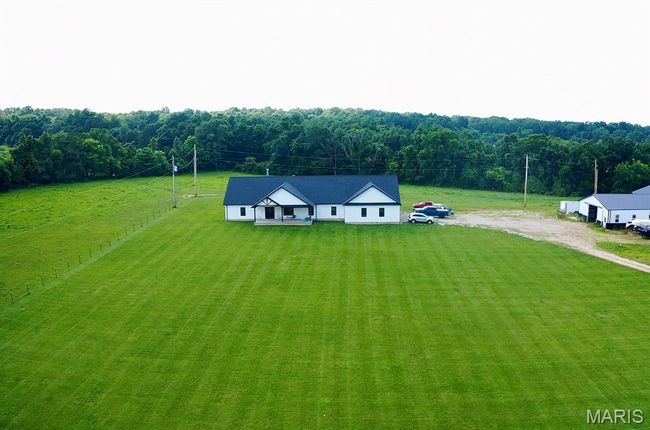 Aerial view of property and surrounding area with a forest | Image 11