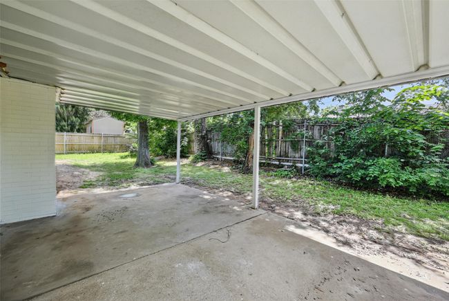 Fenced backyard featuring a patio area and a carport | Image 16