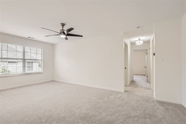 Spare room with light colored carpet, ceiling fan, and baseboards | Image 34