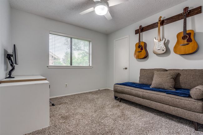 Sitting room featuring carpet flooring, ceiling fan, and a textured ceiling | Image 17