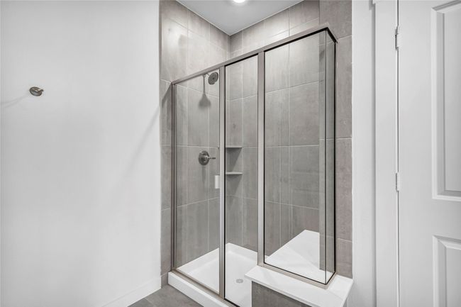 Bright and spacious primary bath suite with dual sink vanity, shower, and private water closet. | Image 21
