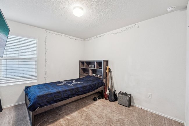 Carpeted bedroom with baseboards and a textured ceiling | Image 14
