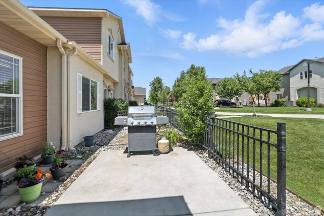 View of patio / terrace featuring a grill and a residential view | Image 22