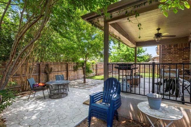 Fenced backyard with ceiling fan and a patio area | Image 34