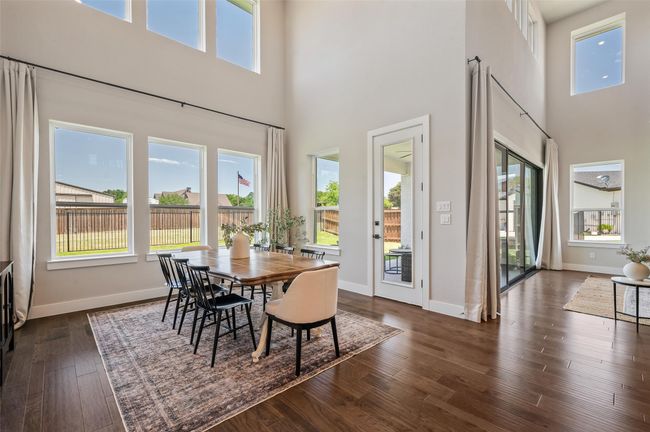 Large kitchen dining nook leads out to covered patio. | Image 11