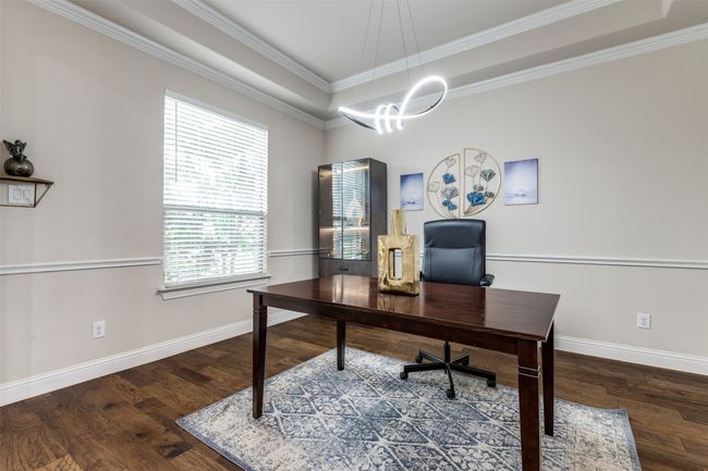 Office area with crown molding, wood finished floors, a chandelier, and a raised ceiling | Image 11