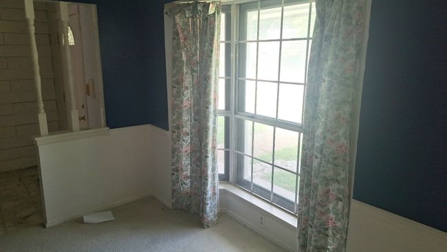 View of carpeted dining room and entry way | Image 12