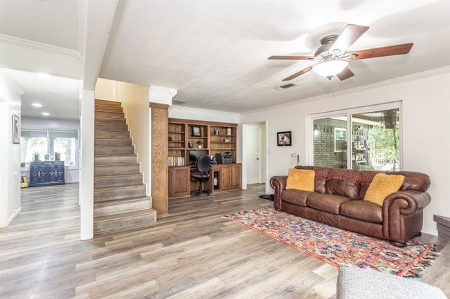 Featuring built in office nook and cabinetry. Cabinetry includes gun cabinet. Up the stairs, you will find 2 guest bedrooms. | Image 12