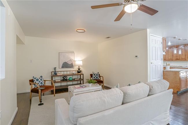 Living room featuring hardwood / wood-style flooring and ceiling fan | Image 16