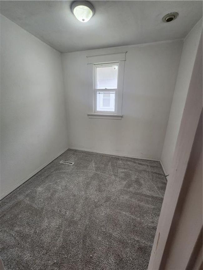Unfurnished room featuring carpet floors and visible vents | Image 16