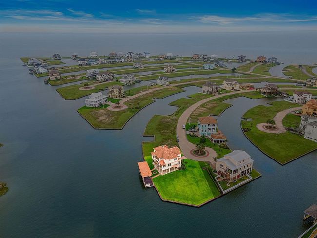 An aerial view of Harborwalk highlighting this magnificent home's prime location on the point of Loggerhead | Image 4