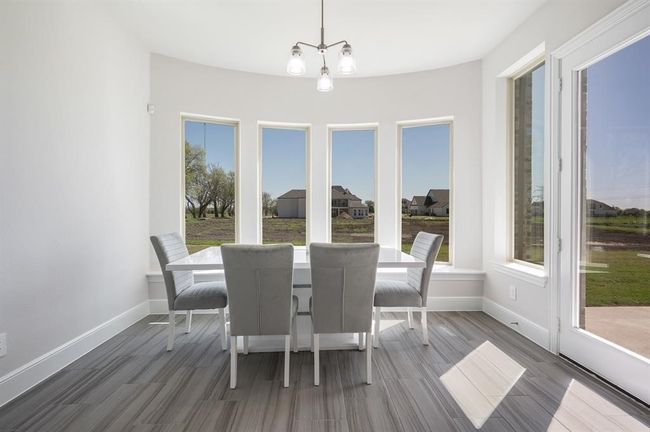 Dining space with wood finished floors and baseboards | Image 10