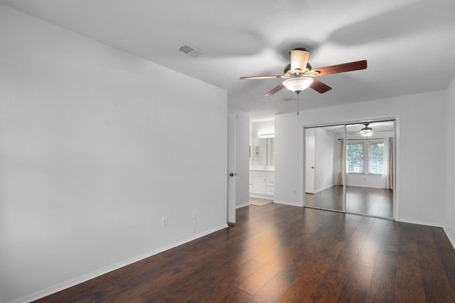 Spare room featuring a ceiling fan and wood finished floors | Image 22