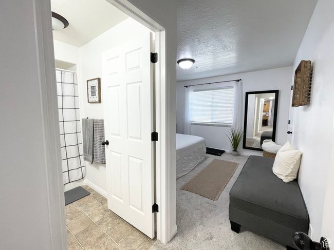 Bathroom featuring a textured ceiling and a shower | Image 14