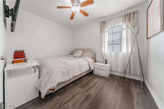 Bedroom featuring a ceiling fan, baseboards, and wood finished floors | Image 22