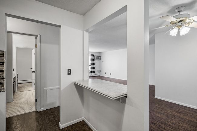 Open to both the dining and living areas, this pass-through offers seamless connection with family and guests plus a spot for casual seating or quick meals. | Image 12
