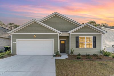 View of front of property featuring a yard and a garage | Image 3