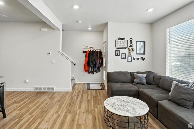 Living area with stairway, new light wood-style LVP floors, and recessed lighting | Image 32