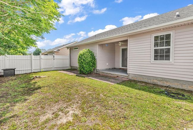 View of yard featuring fence, a ceiling fan, a patio, and a gate | Image 23