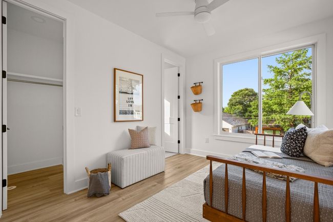 Bedroom with light wood-style flooring, baseboards, and a ceiling fan | Image 9