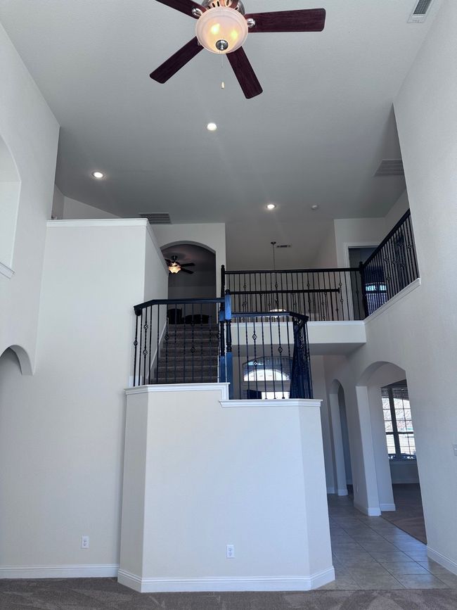 Stairs with visible vents, arched walkways, ceiling fan, and recessed lighting | Image 17