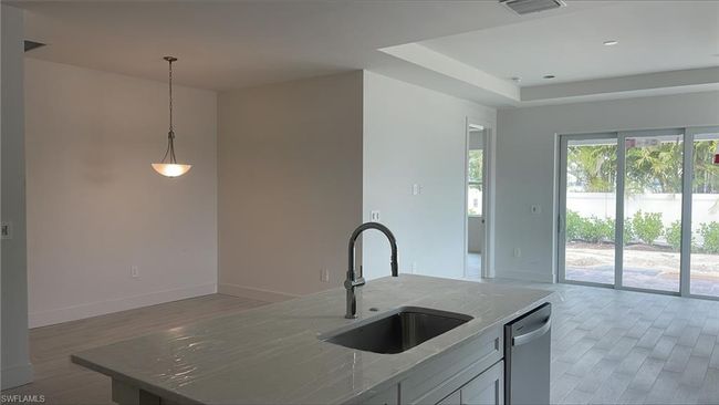 Casual dining area with light fixture | Image 8