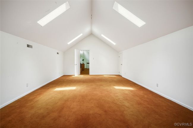 Bonus room featuring a skylight, vaulted ceiling, and light carpet | Image 26