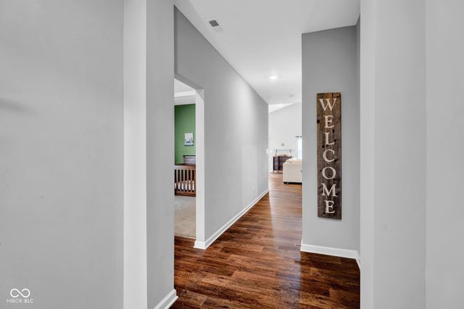hallway with visible vents, dark wood-style flooring, baseboards, and recessed lighting | Image 6