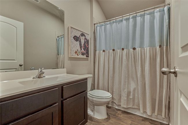 Guest bath #1 with tub/shower combo and a solid surface countertop. | Image 10