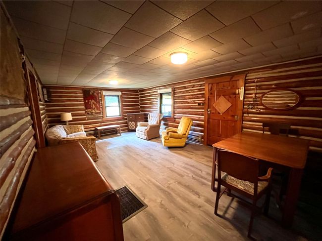 Living area featuring rustic walls and wood finished floors | Image 14