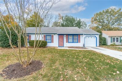 Single story home featuring a garage and a front lawn | Image 1