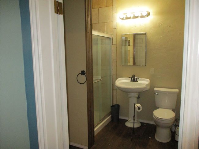 Bathroom with toilet, wood-type flooring, and walk in shower | Image 28
