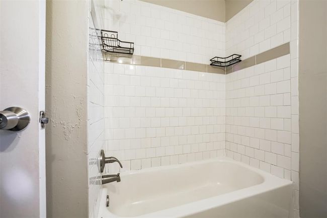 Hall bath has tub/tile surround | Image 7