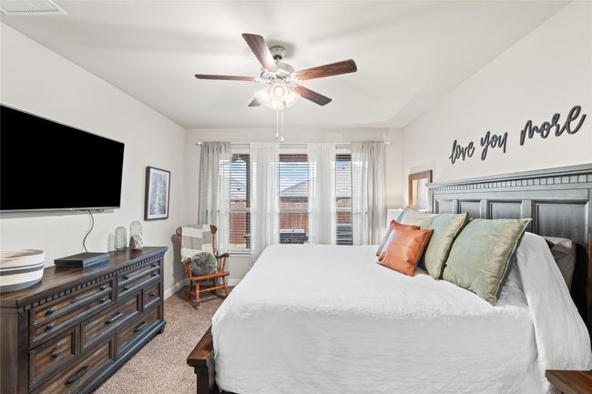 Bedroom featuring visible vents, baseboards, carpet, and a ceiling fan | Image 16